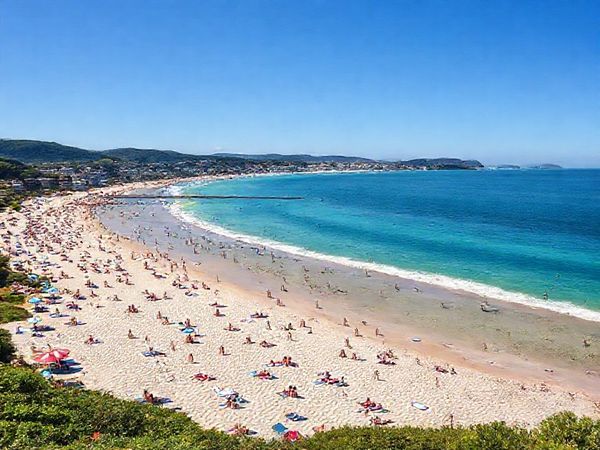 A high definition image of the stunning North Shore District in New Zealand, showcasing its vibrant summer beaches with sun-seekers lounging on Takapuna and Milford beaches. The scene captures the dazzling blue waters of the Hauraki Gulf, surrounded by lush green landscapes and colorful coastal flora. Lively festivals and outdoor events fill the atmosphere with energy, while a gentle coastal breeze adds to the idyllic setting, inviting viewers to immerse in this perfect Kiwi beach experience.