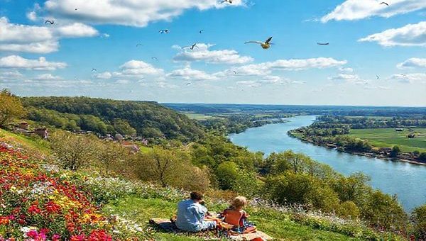 A breathtaking view of Sachsen-Anhalt during spring, showcasing vibrant blooming flowers and green landscapes along the Elbe River. Include the Fläming Heath in full color, a peaceful picnic scene with a family enjoying the surroundings. The sky is bright blue, dotted with fluffy clouds, evoking a sense of renewal and tranquility. Capture the essence of nature awakening, with birds in flight, all in high definition.