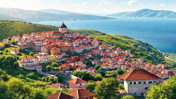 **Image Prompt:** Create a high-definition illustration of a vibrant Bulgarian landscape featuring the ancient city of Plovdiv with its colorful architecture, lush green hills, and the sparkling Black Sea in the background. Include elements representing Bulgarian culture, such as traditional folk music instruments, symbolic patterns, and a Cyrillic alphabet sign. The scene should evoke a sense of exploration, learning, and connection to family heritage, inviting viewers to immerse themselves in the beauty and richness of the Bulgarian experience.