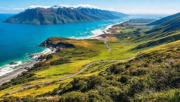 **Prompt:** Create a breathtaking high-definition image of New Zealand's West Coast Region, showcasing its rugged landscapes in summer. Include vibrant greenery, the dramatic coastline along the Great Coast Road overlooking the Tasman Sea, and the accessible Franz Josef and Fox Glaciers. Capture the lively atmosphere filled with adventure seekers, lush rainforests, and a clear blue sky, inviting viewers to explore this magnificent destination.