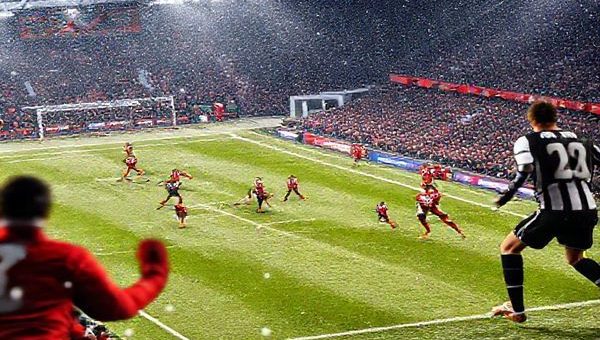 High definition image of a thrilling Scottish Premiership football match between Aberdeen and St Mirren at Pittodrie Stadium in December 2025, capturing the intensity of the game with players in action, vibrant team colors, and an electric atmosphere filled with passionate fans. Show Aberdeen in their red strips showcasing their defensive tactics against St Mirren's dynamic attacking style in their black and white kit, with a backdrop of snowy Scottish terrain.