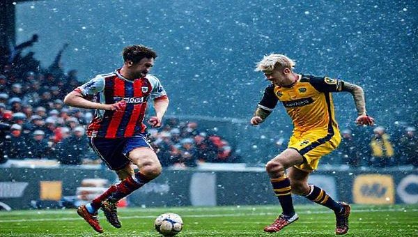 A high-definition scene of a Scottish football match between East Fife and Inverness in December 2025, set against a dramatic winter backdrop. Capture the intensity on the players' faces as East Fife employs a high-pressing tactic, while Inverness showcases their patient, possession-based style. Include passionate fans in the stands waving flags and scarves, the atmosphere electric, with snow gently falling around the stadium. Emphasize contrasting team colors and dynamic movements on the pitch, uniting the essence of fierce competition and vibrant Scottish football culture.