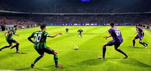 A high-definition image of a dramatic football match between Sassuolo and Fiorentina in December 2025. The pitch is illuminated under bright stadium lights, with fans cheering in the stands. Sassuolo players, in their green and black uniforms, are pressing forward dynamically, while Fiorentina players, in their purple kits, are poised to counter, showcasing a battle of styles. The atmosphere is electric, capturing the intensity of this Serie A showdown, with a tactical duel evident in the players' focused expressions and strategic formations.