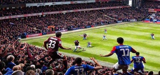 High definition image of a thrilling Premier League match between Burnley and Crystal Palace in December 2025. The stadium is packed with passionate fans, with banners and flags waving. Burnley's players, clad in their deep claret kits, are executing a counter-attack, showcasing their determination and grit. Meanwhile, Crystal Palace players in vibrant blue and red jerseys are displayed in dynamic movement, emphasizing their flair and technical prowess on the ball. Capture the intensity of the game, the clash of styles, and the vibrant atmosphere of football.