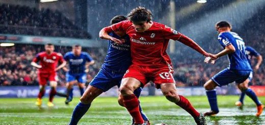 A high-definition image of a thrilling football match scene: two teams in vibrant kits, Stevenage in bright red and Cardiff in deep blue, clashing on a rain-soaked pitch under stadium lights. The atmosphere is electric, with passionate fans cheering from the stands. Focus on an intense moment where a Stevenage player tackles a Cardiff striker, showcasing the determination and skill of both teams. Capture the dynamic energy and emotion of the game, with droplets of rain reflecting the colorful lights.