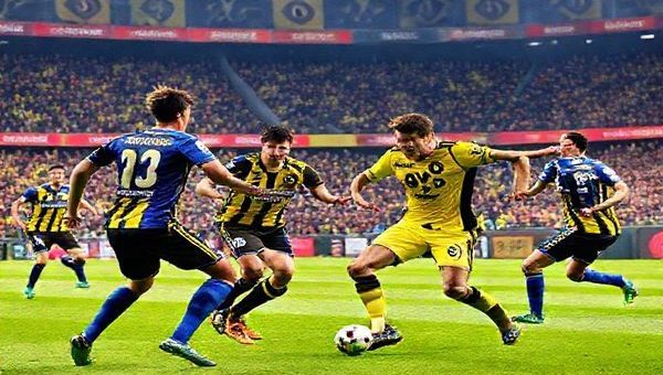 High-definition image of an electrifying football match between Borussia Dortmund and Hoffenheim, set in a vibrant stadium filled with cheering fans. Capture the dynamic intensity of the players in action, with Dortmund's attacking squad in their distinctive yellow and black kits, showcasing their high-tempo style, juxtaposed against Hoffenheim's disciplined defense in their blue uniforms. Include a backdrop of colorful banners and the energy of the crowd, emphasizing the tactical duel as "fire meets ice" in this Bundesliga showdown.