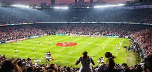 A high definition image capturing the intense atmosphere of a women's football match between Real Madrid Women and Wolfsburg Women at the Alfredo Di Stéfano Stadium. The scene shows vibrant fans in the stands, colorful team jerseys clashing on the field, and dynamic action as players like Claudia Zornoza and Alexandra Popp engage in a tactical battle. Dramatic lighting enhances the urgency and excitement of this Women's Champions League showdown on December 9, 2025, with a backdrop of the iconic Madrid skyline.