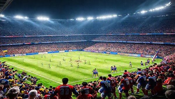 "High-definition image of a dramatic football match scene depicting the fierce rivalry between Ukraine and Iceland during a World Cup Qualifier. Capture the intensity of the game with Ukrainian players showcasing their dynamic plays and Icelandic defenders organized in a disciplined formation. Include fans in vibrant blue and yellow for Ukraine, and in striking red and blue for Iceland, passionately supporting their teams. The backdrop should feature a packed stadium under floodlights, highlighting the stakes of national pride and tactical genius in this pivotal clash."