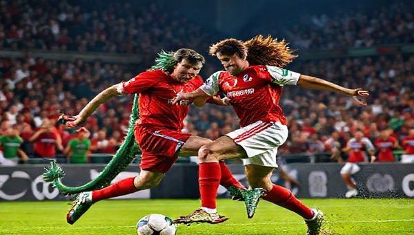 "An intense football match scene depicting a fierce clash between the legendary Welsh Dragon and the resilient North Macedonian Lion on a vibrant green pitch. The atmosphere is electric, with passionate fans cheering in the background, showcasing national pride. Capture dynamic action as players engage in a tactical battle, with Gareth Bale soaring past his opponent, while Eljif Elmas orchestrates a counterattack. Bright stadium lights illuminate the fierce colors of both teams' jerseys, creating a high-stakes, dramatic moment in high definition."