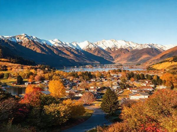 A breathtaking scene in Selwyn District, New Zealand, showcasing the four distinct seasons: summer with sunlit lakes and vibrant markets, winter featuring snow-capped mountains and cozy fires, autumn adorned in golden leaves and harvest festivals, and spring bursting with blooming flowers and bustling farmer's markets. Capture the beauty of this diverse landscape framed by the Southern Alps, inviting visitors to engage in outdoor adventures and local culture throughout the year. Emphasize the harmony between nature and community life, creating a vibrant tapestry of Kiwi charm.