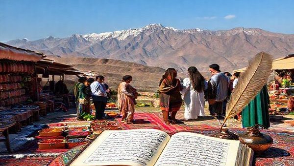 A serene Persian landscape featuring a vibrant bazaar filled with intricate rugs and colorful spices, with an open book of Persian poetry resting on a table. In the background, mountains rise majestically, and a vintage inkpot with a quill symbolizes the beauty of the Persian script. A group of diverse learners, engaged in conversation with native speakers, immerses themselves in the culture and language, reflecting the joy of learning.