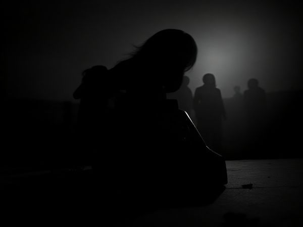 **Image Prompt:** Create a high-definition image depicting a haunting scene inspired by "Black Phone 2". Feature a vintage telephone wrapped in shadows, with faint ghostly figures of women emerging from the darkness, symbolizing silenced voices. The backdrop should be a surreal, monochrome landscape that combines cinematic horror elements with an emotional depth. Include a contrast of light and dark that highlights the tension and anticipation in the atmosphere, reflecting the film's feminist themes.